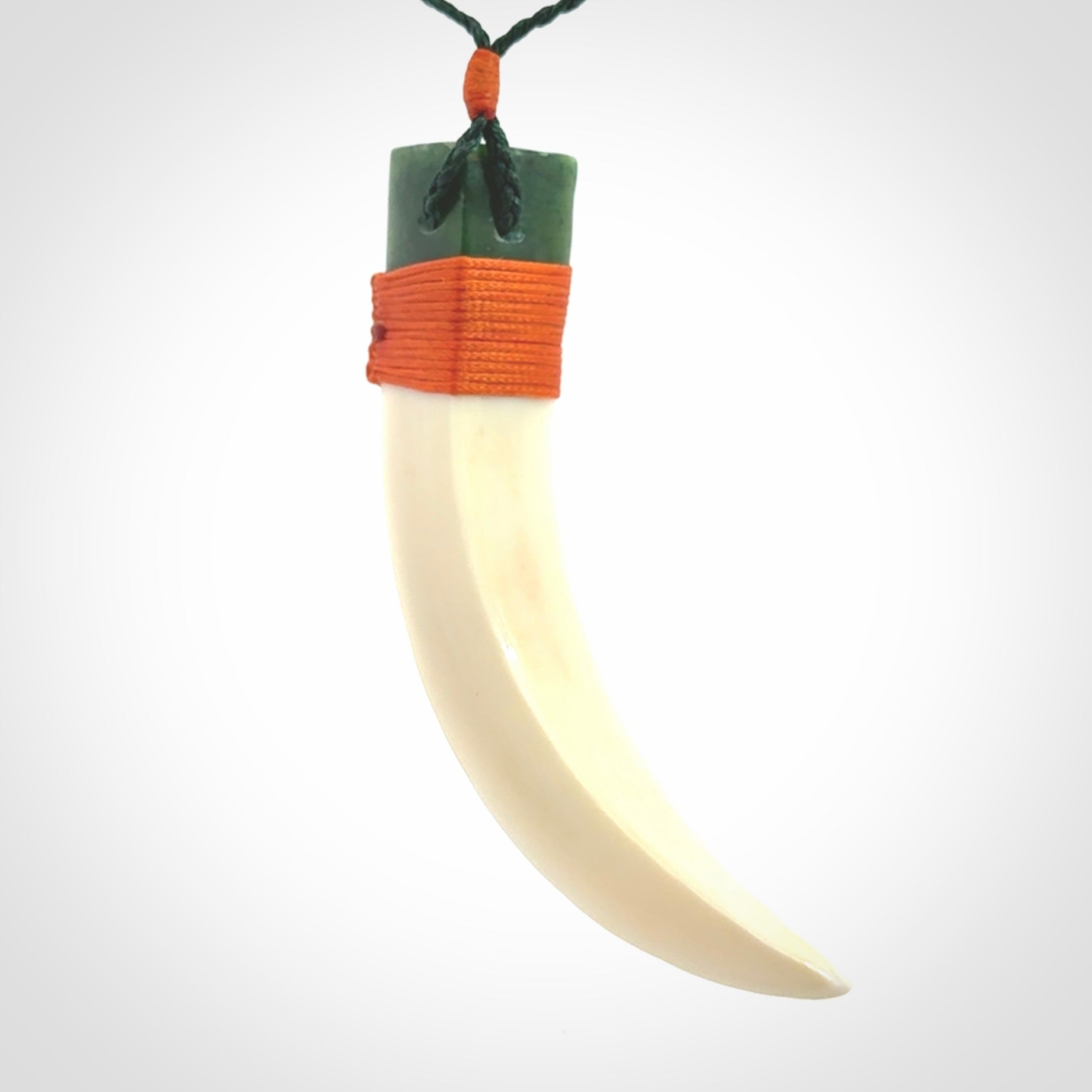 Boars Tusk Pendant with a jade cap. Hand made pendant carved from a boars tusk.