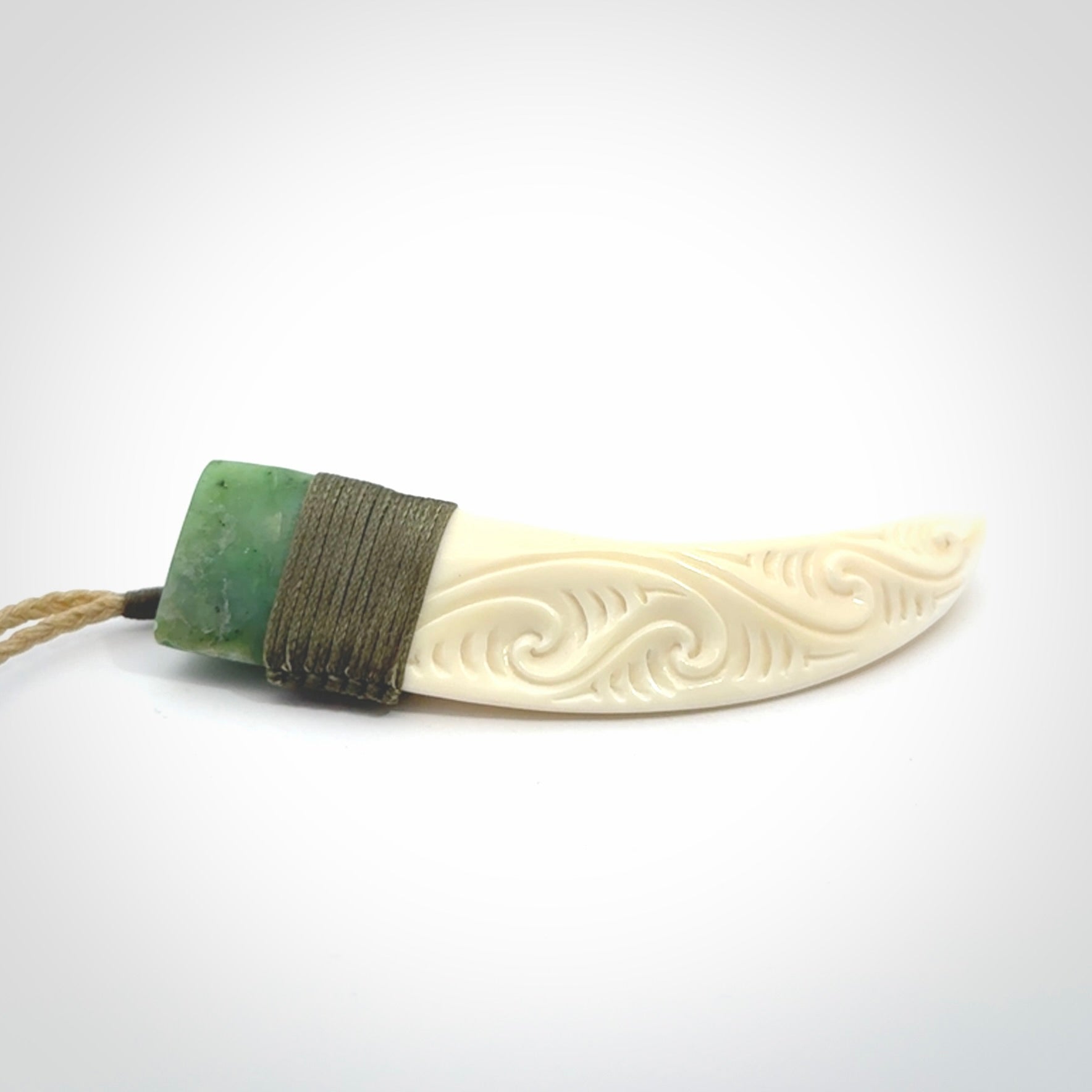 Boars Tusk Pendant with a jade cap. Hand made pendant carved from a boars tusk.