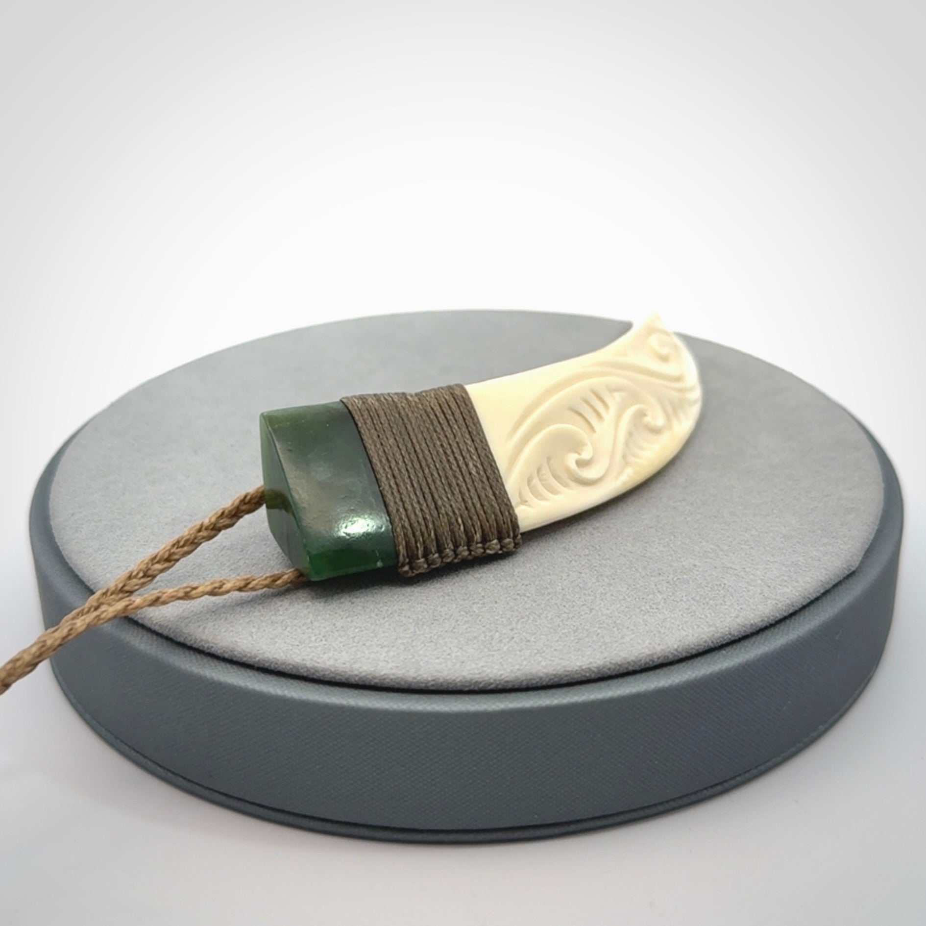 Hand carved boars tusk and jade pendant