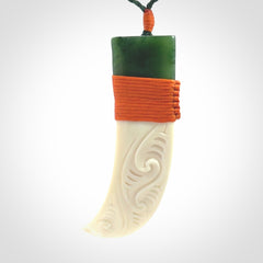Boars Tusk Pendant with a jade cap. Hand made pendant carved from a boars tusk.