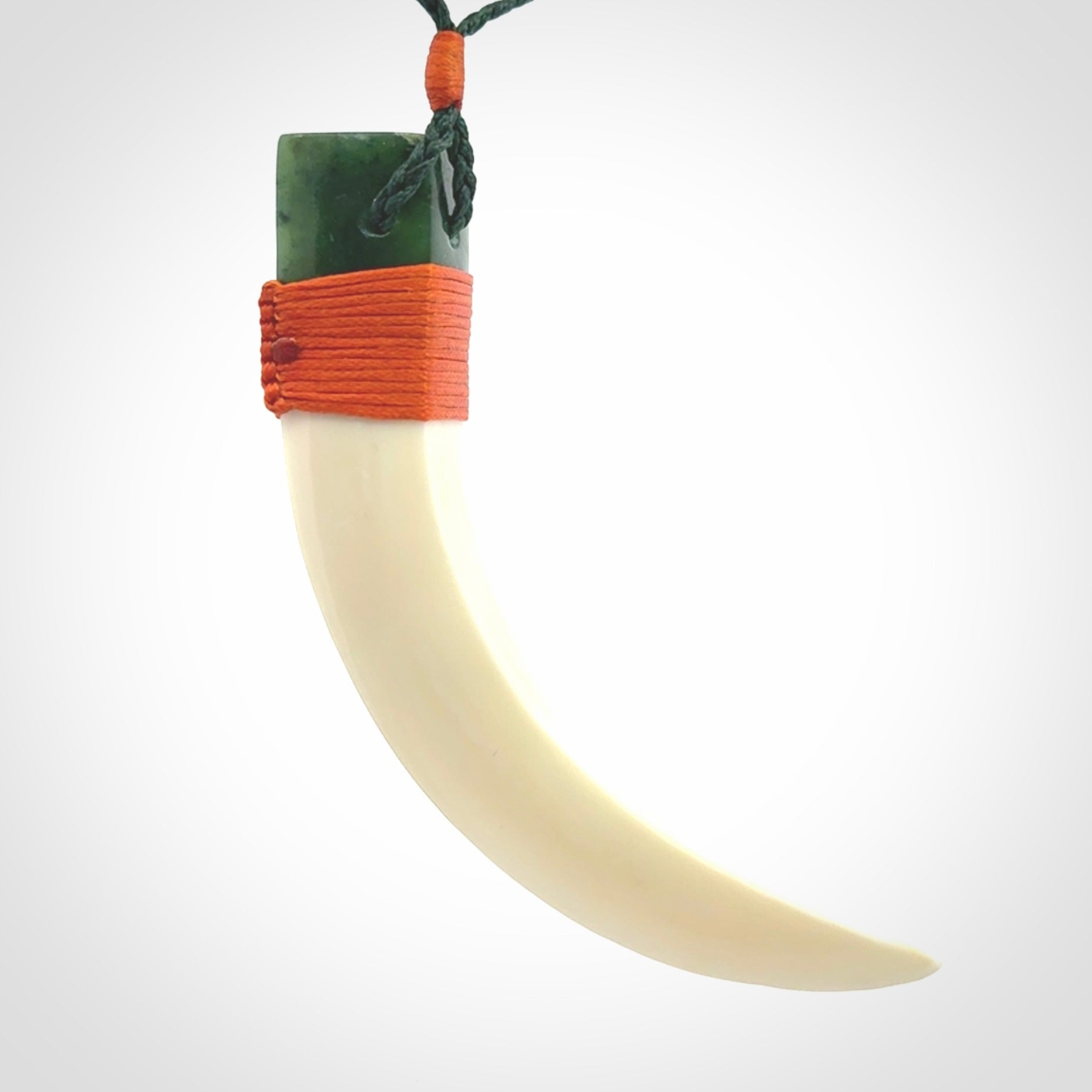 Boars Tusk Pendant with a jade cap. Hand made pendant carved from a boars tusk.