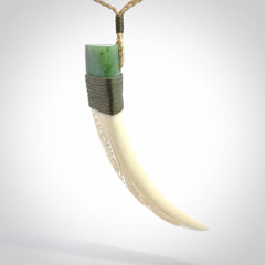 Boars Tusk Pendant with a jade cap. Hand made pendant carved from a boars tusk.