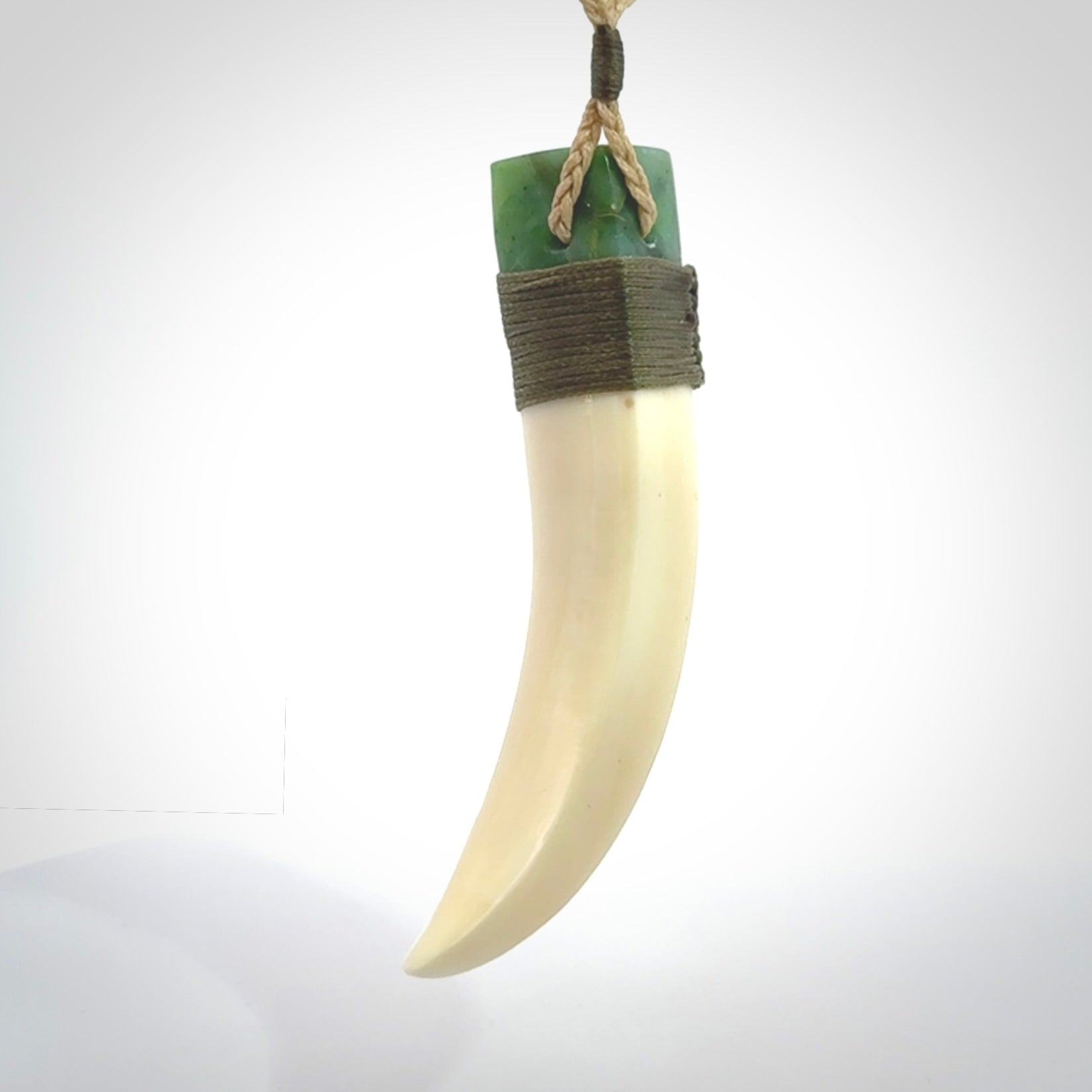 Boars Tusk Pendant with a jade cap. Hand made pendant carved from a boars tusk.