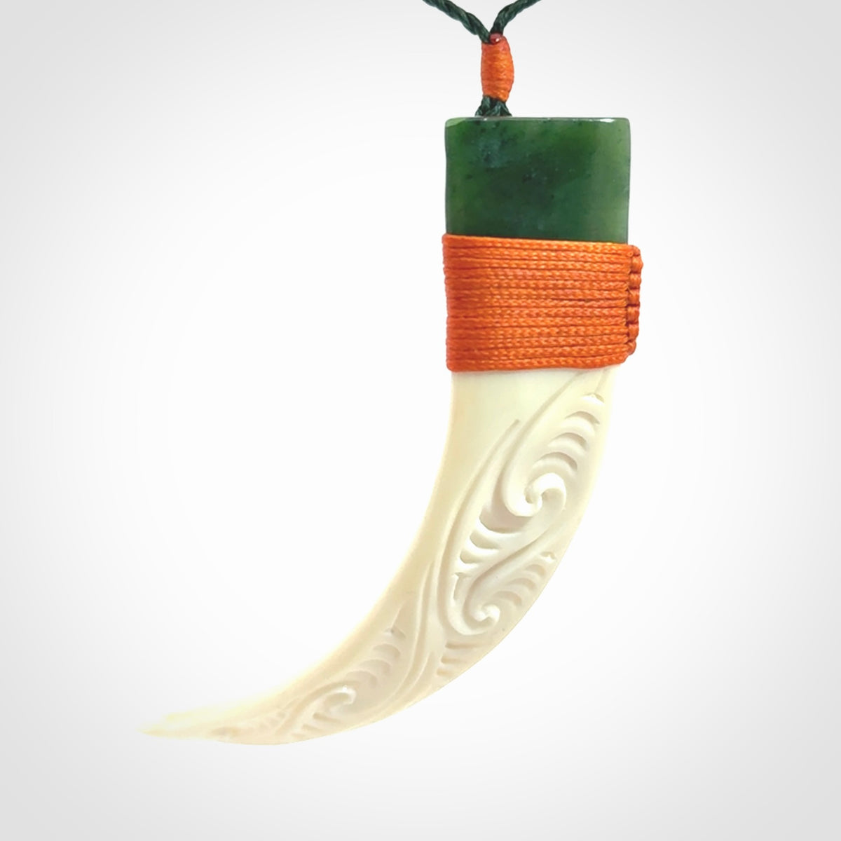 Boars Tusk Pendant with a jade cap. Hand made pendant carved from a boars tusk.
