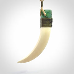 Boars Tusk Pendant with a jade cap. Hand made pendant carved from a boars tusk.