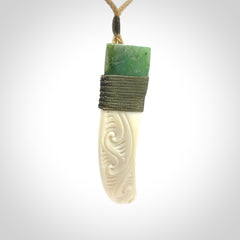 Boars Tusk Pendant with a jade cap. Hand made pendant carved from a boars tusk.