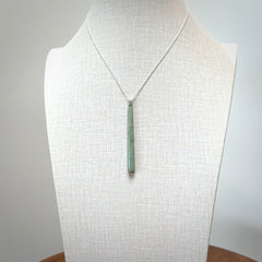A hand carved New Zealand Jade Drop pendant with sterling silver clasp and chain.