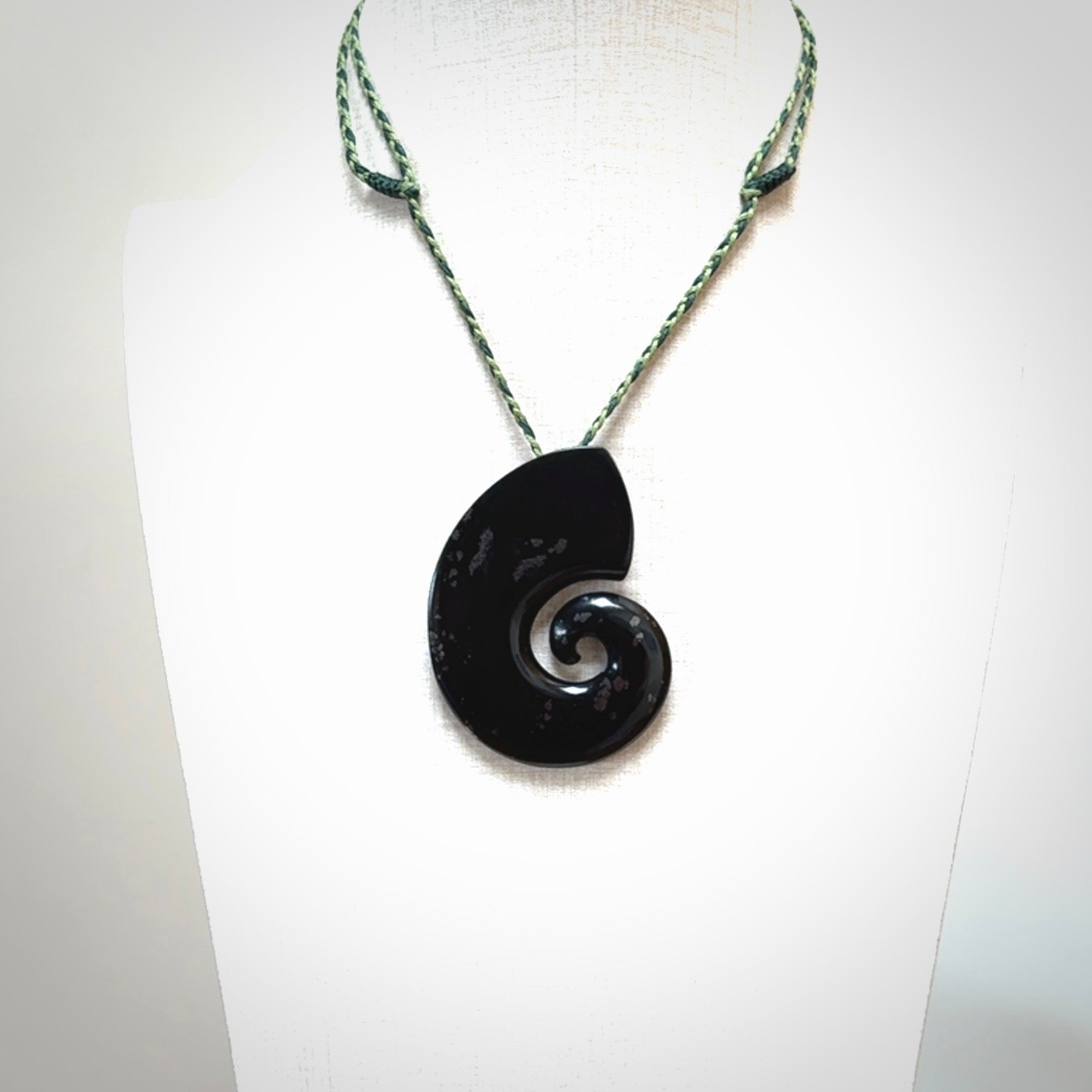 A hand carved koru pendant from New Zealand Tangiwai Pounamu. The cord is a Fern/Manuka Green colour and is an adjustable length. A large hand made Koru necklace by New Zealand artist Kerry Thompson.