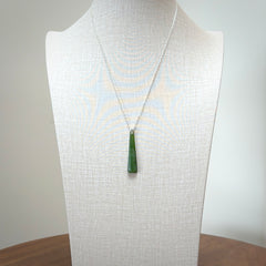 A hand carved New Zealand Jade Drop pendant with sterling silver clasp and chain.