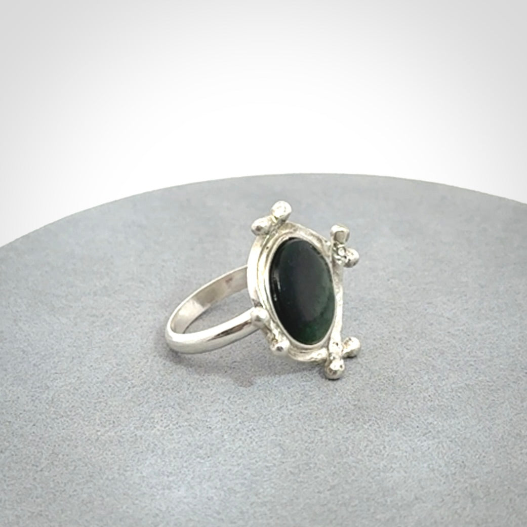 This is a handcrafted New Zealand Pounamu, Jade and sterling silver ring. 