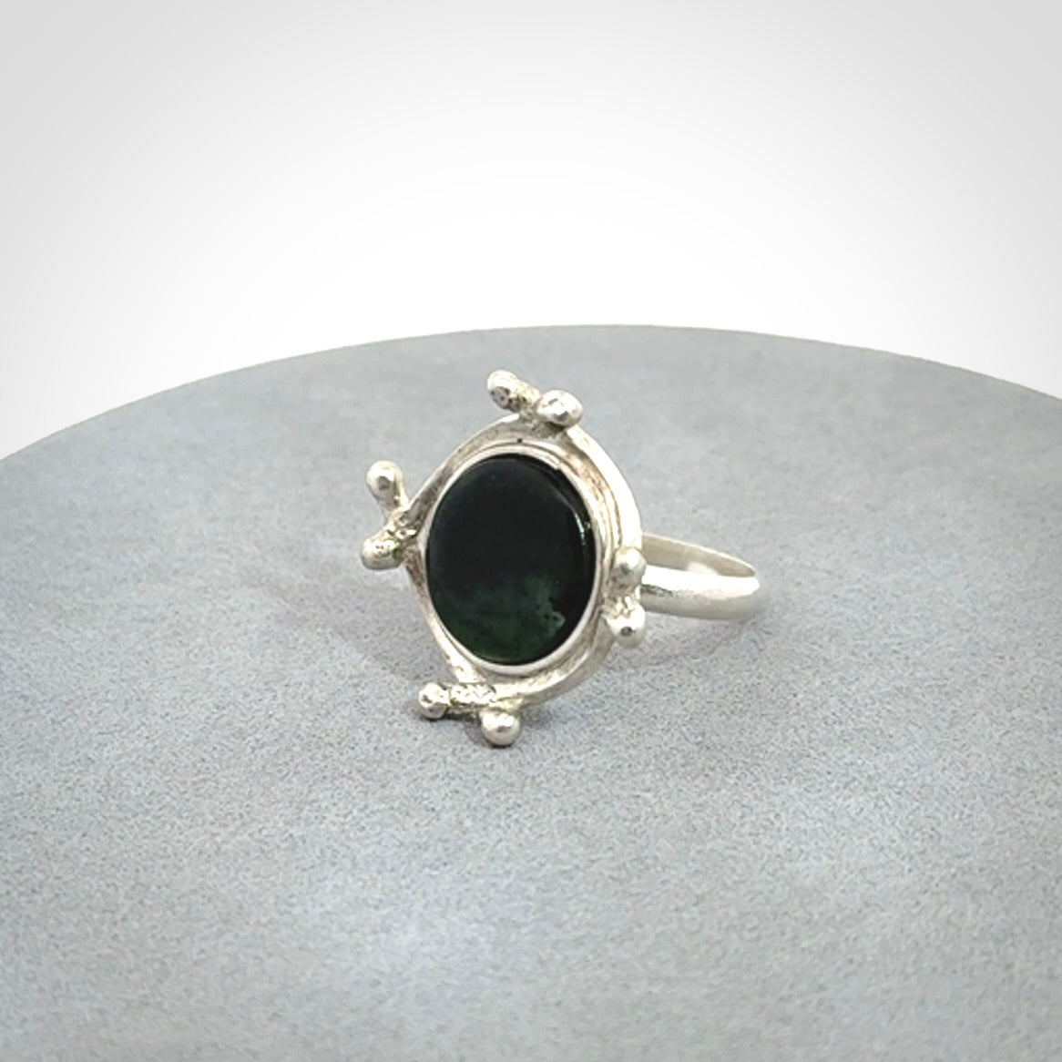 This is a handcrafted New Zealand Pounamu, Jade and sterling silver ring. 