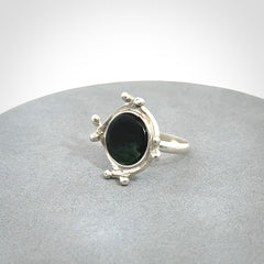 This is a handcrafted New Zealand Pounamu, Jade and sterling silver ring. 