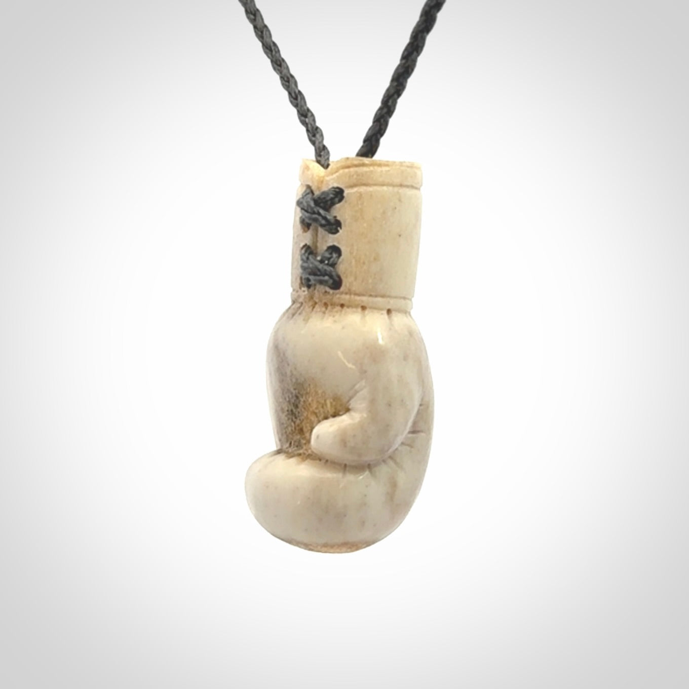 Hand carved boxing glove made from deer antler. The cord is adjustable so that you can wear this where it suits you best.