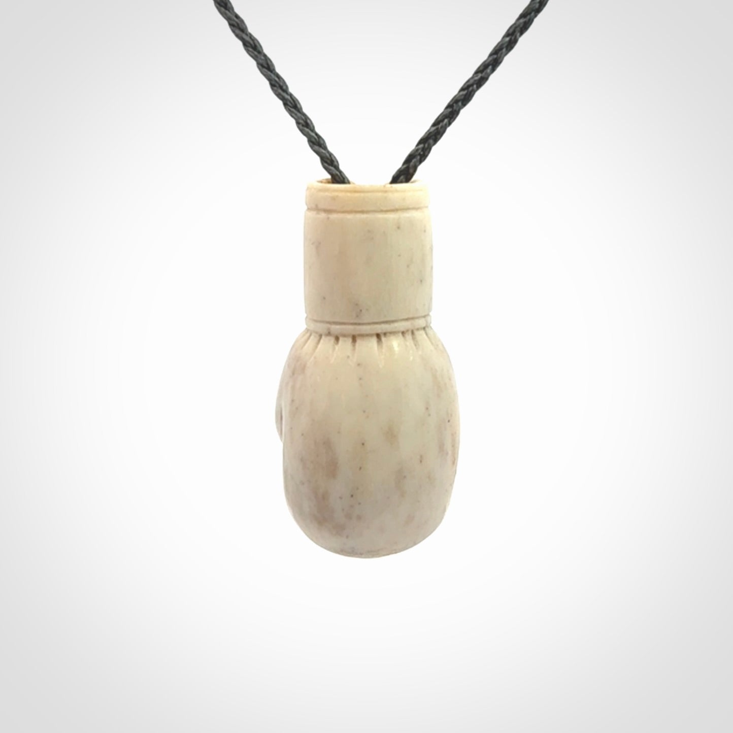 Hand carved boxing glove made from deer antler. The cord is adjustable so that you can wear this where it suits you best.