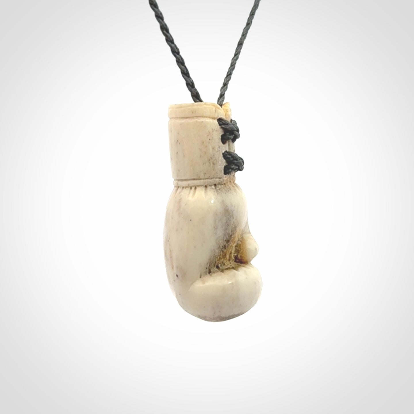 Hand carved boxing glove made from deer antler. The cord is adjustable so that you can wear this where it suits you best.