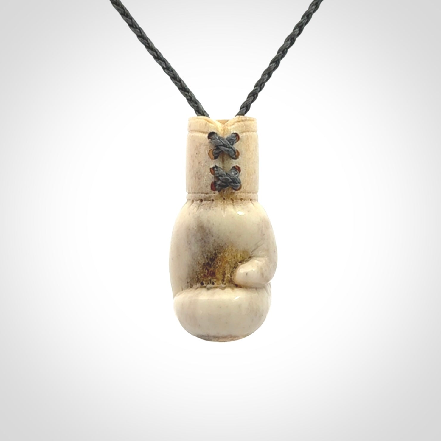 Hand carved boxing glove made from deer antler. The cord is adjustable so that you can wear this where it suits you best.