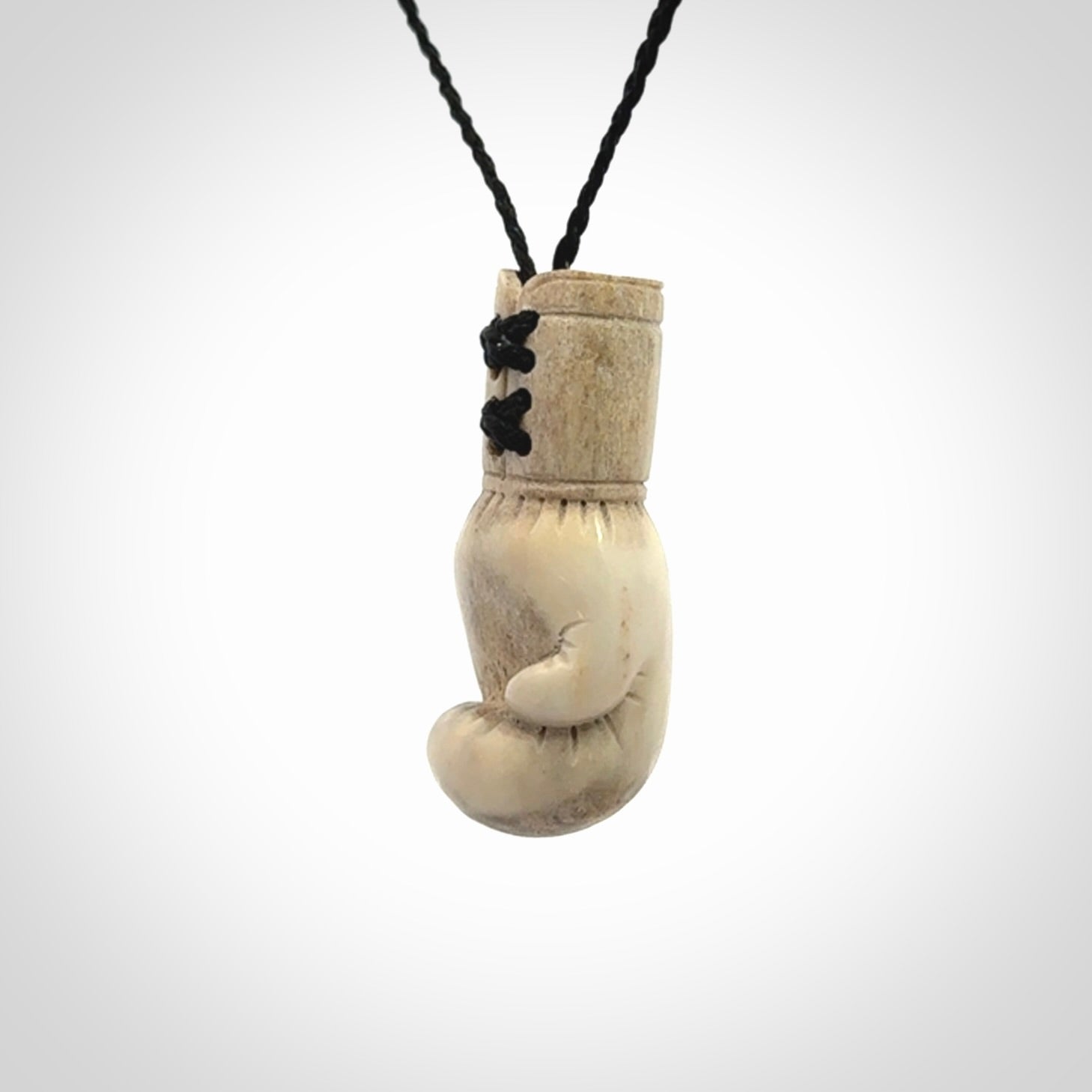 Hand carved boxing glove made from deer antler. The cord is adjustable so that you can wear this where it suits you best.
