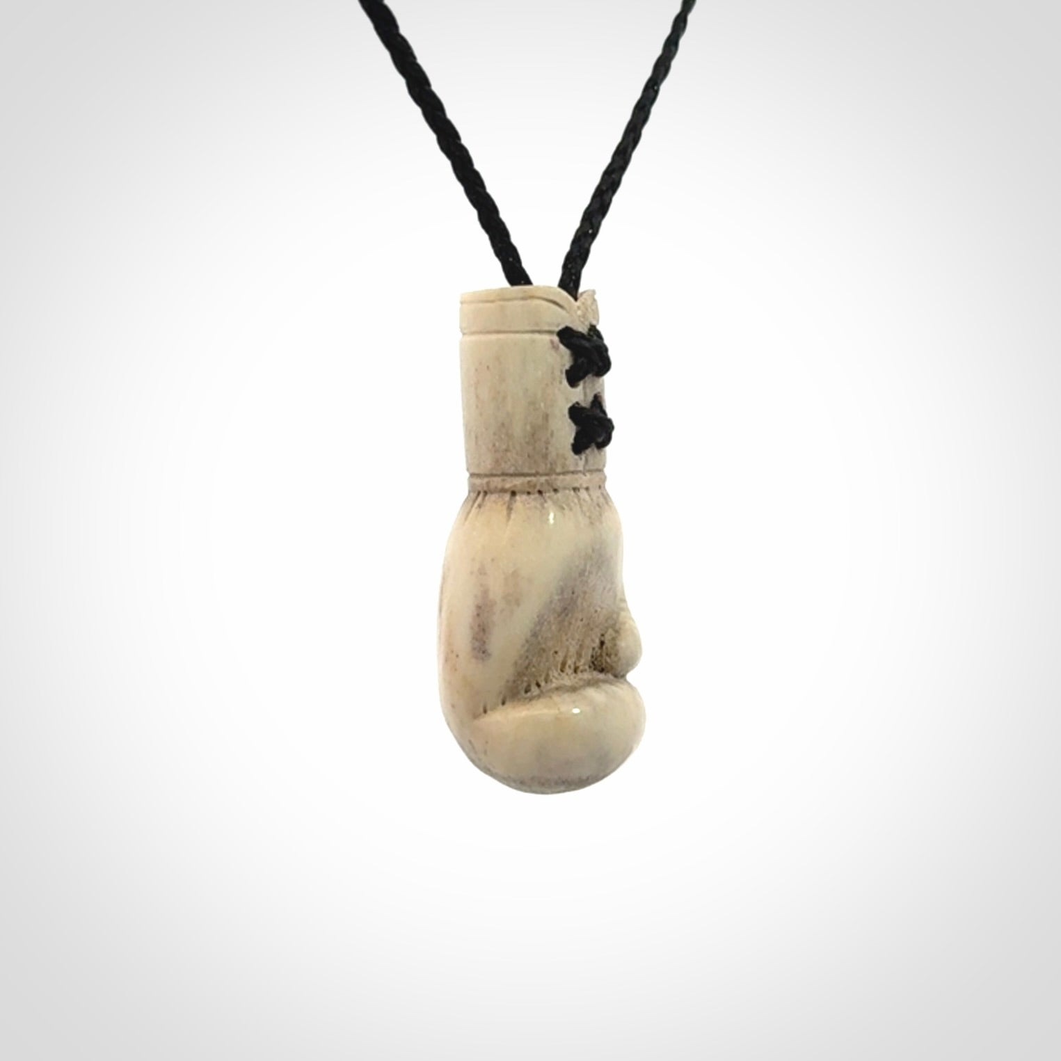 Hand carved boxing glove made from deer antler. The cord is adjustable so that you can wear this where it suits you best.