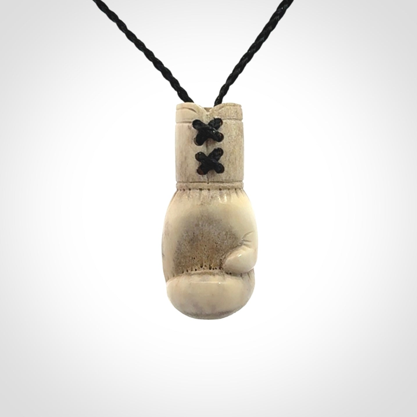 Hand carved boxing glove made from deer antler. The cord is adjustable so that you can wear this where it suits you best.