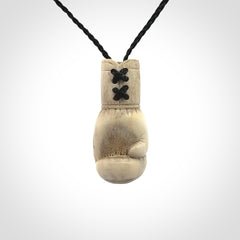 Hand carved boxing glove made from deer antler. The cord is adjustable so that you can wear this where it suits you best.