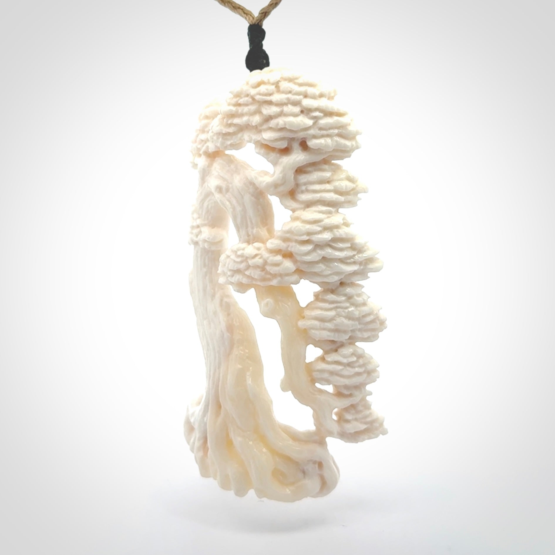 This is a beautiful hand carved tree pendant. It is a wonderfully detailed pendant that we have carved in natural, untreated bone. We provide this with a tan coloured adjustable cord and shipping is included worldwide.