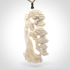 This is a beautiful hand carved tree pendant. It is a wonderfully detailed pendant that we have carved in natural, untreated bone. We provide this with a tan coloured adjustable cord and shipping is included worldwide.