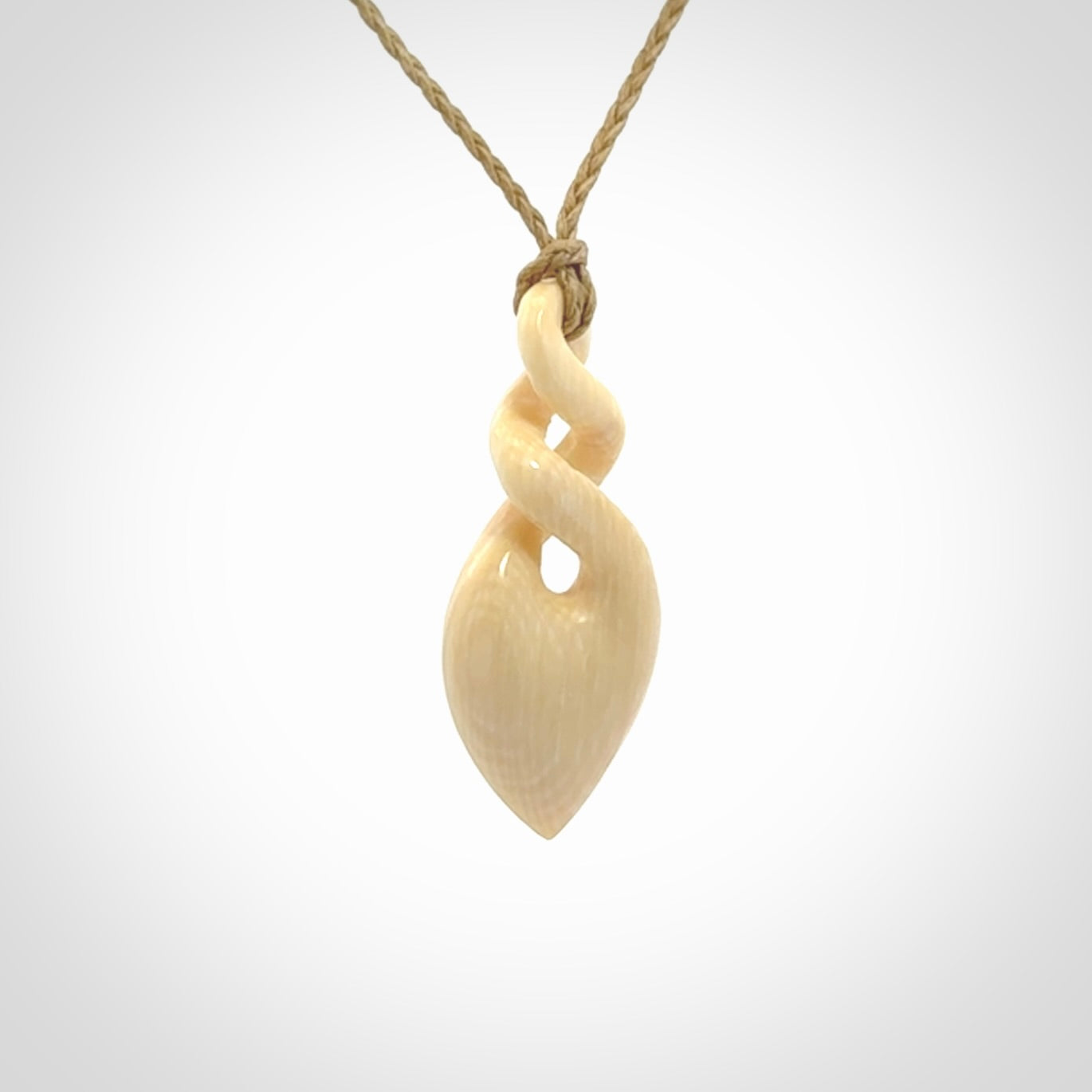 Elegant and striking twist pendants carved from mammoth tusk that's over 30,000 years old - a beautiful and ancient material.