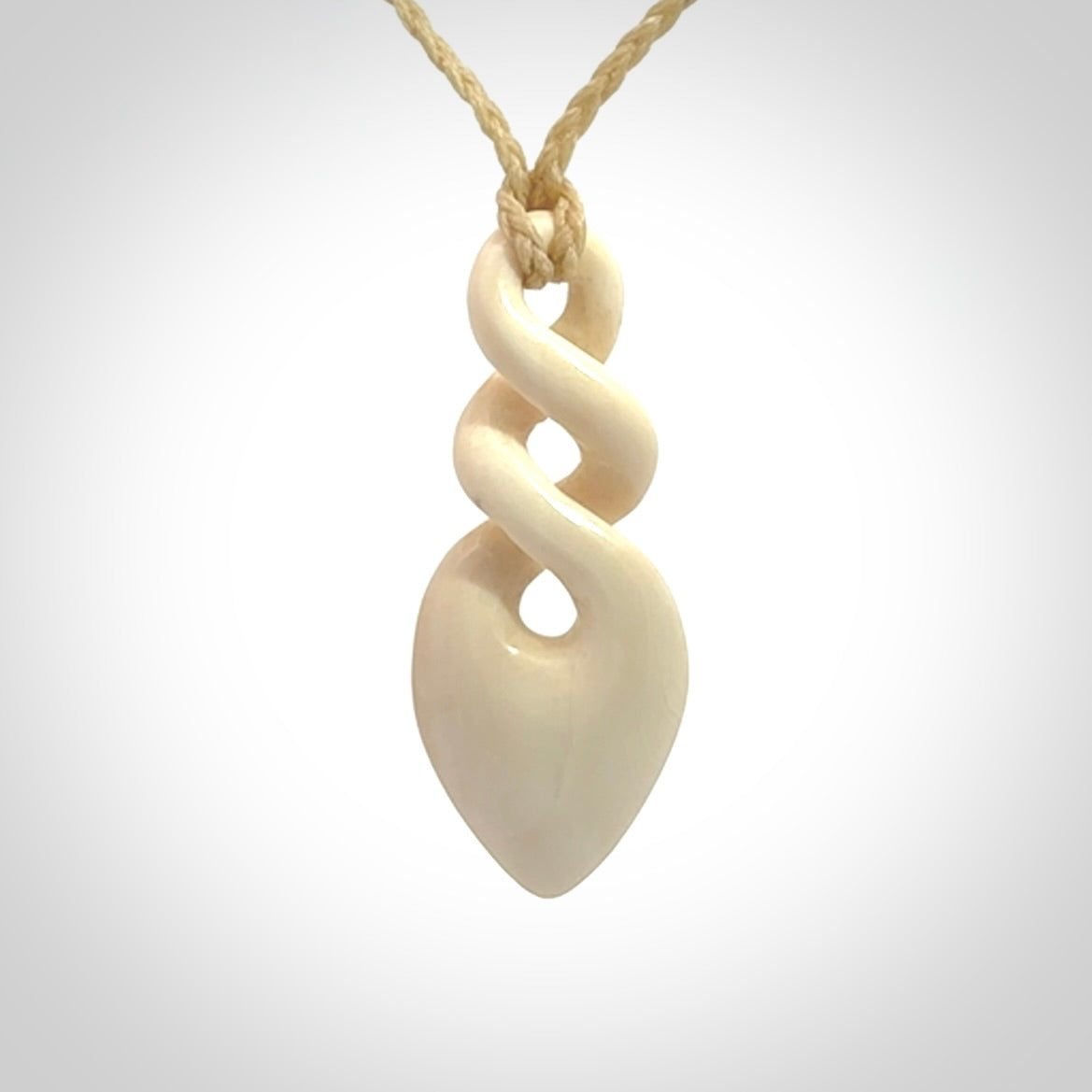 Hand carved woolly mammoth ivory twist pendant. Made by NZ Pacific.