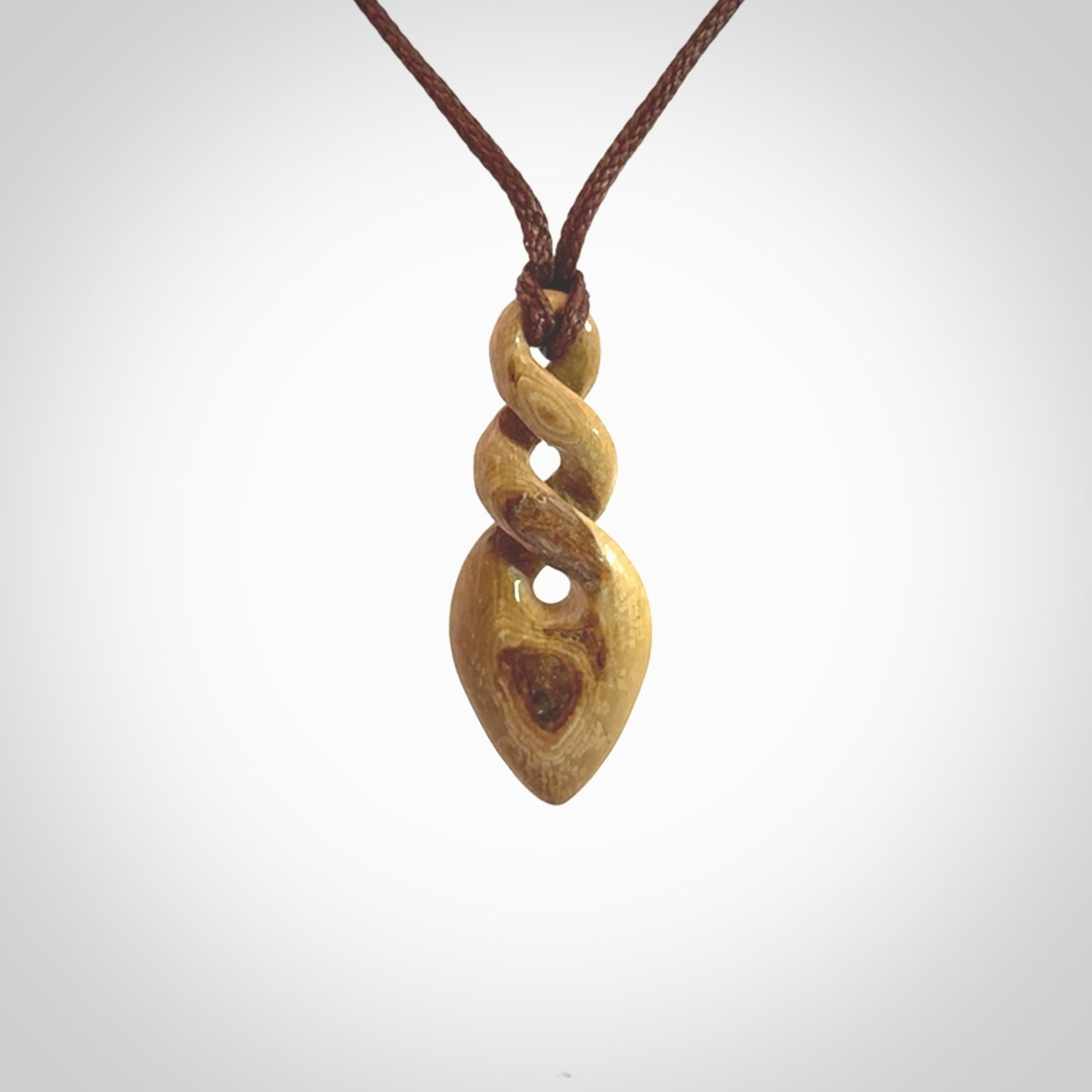 Hand carved woolly mammoth tusk double twist pendant. Made by NZ Pacific.