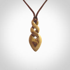 Hand carved woolly mammoth tusk double twist pendant. Made by NZ Pacific.