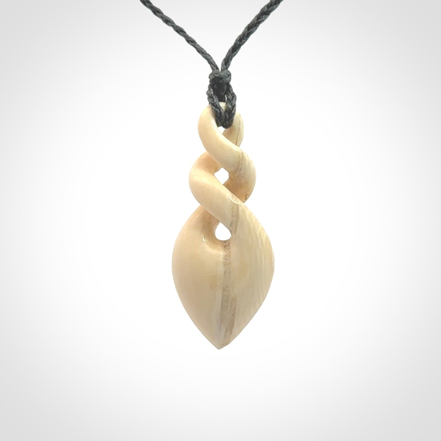 Elegant and striking twist pendants carved from mammoth tusk that's over 30,000 years old - a beautiful and ancient material.