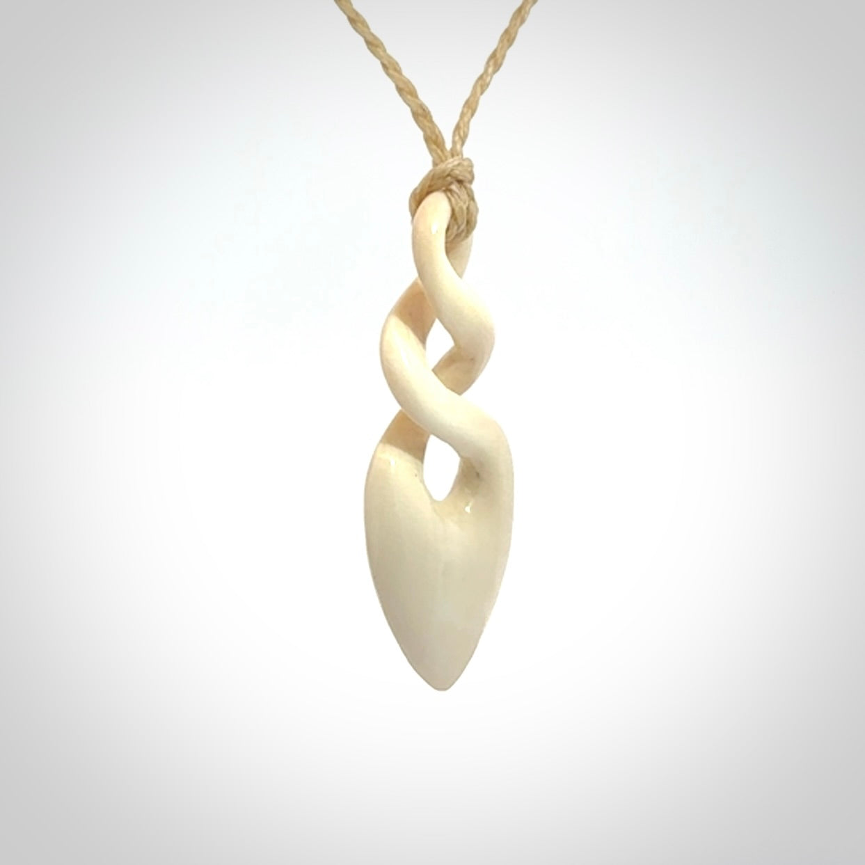 Hand carved woolly mammoth ivory twist pendant. Made by NZ Pacific.