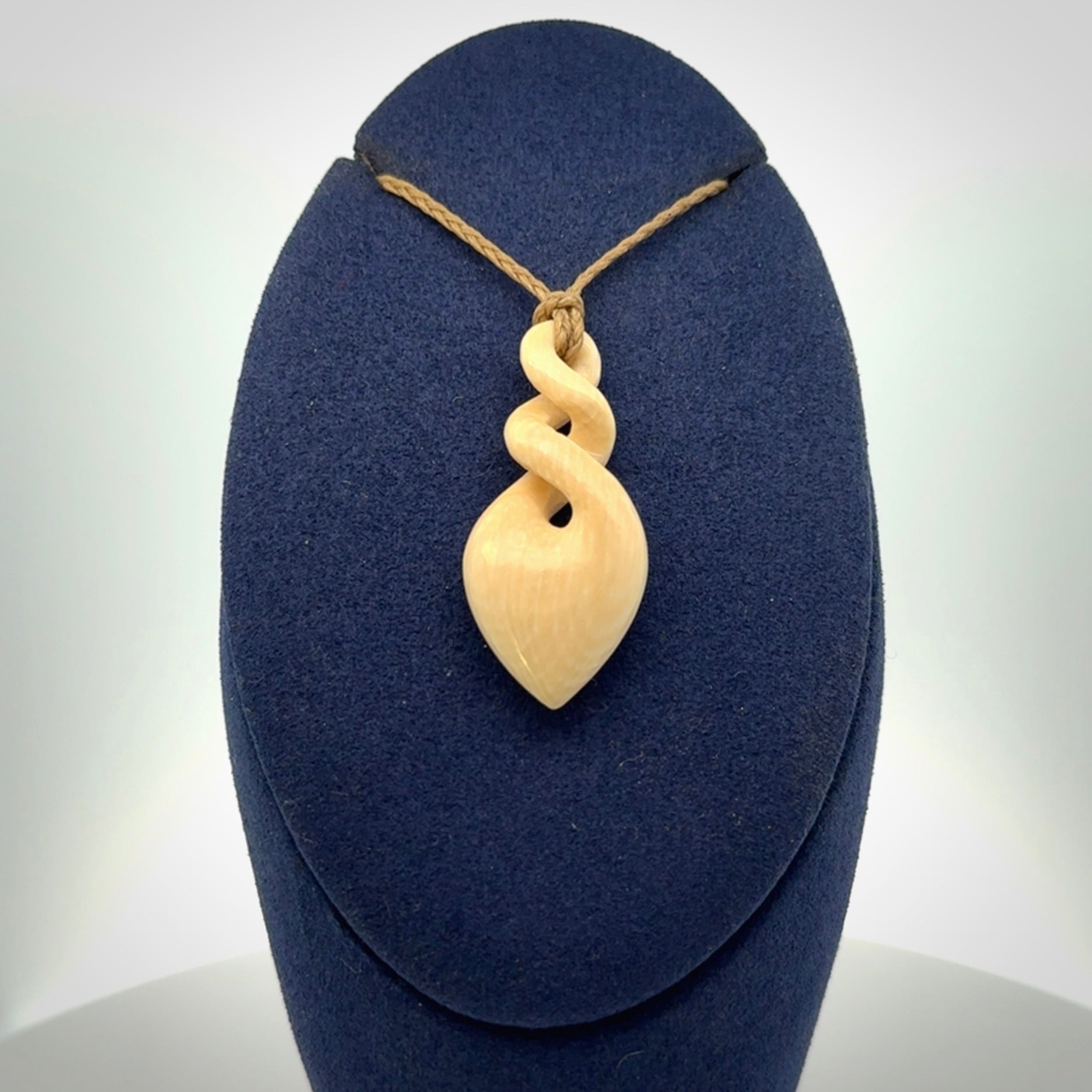 Elegant and striking twist pendants carved from mammoth tusk that's over 30,000 years old - a beautiful and ancient material.