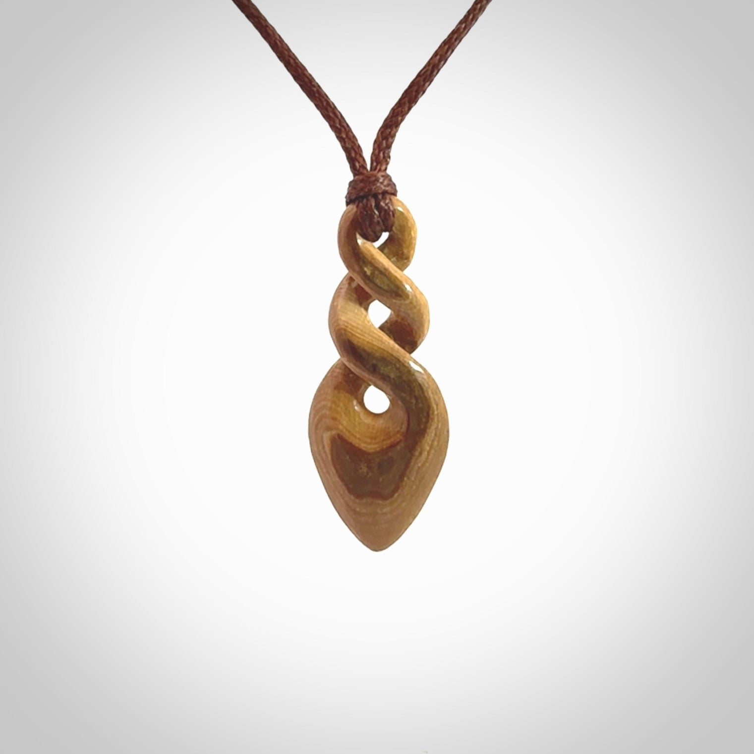 Hand carved woolly mammoth tusk double twist pendant. Made by NZ Pacific.