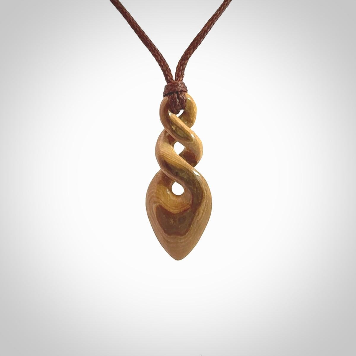 Hand carved woolly mammoth tusk double twist pendant. Made by NZ Pacific.