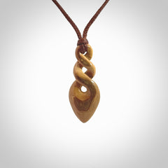 Hand carved woolly mammoth tusk double twist pendant. Made by NZ Pacific.