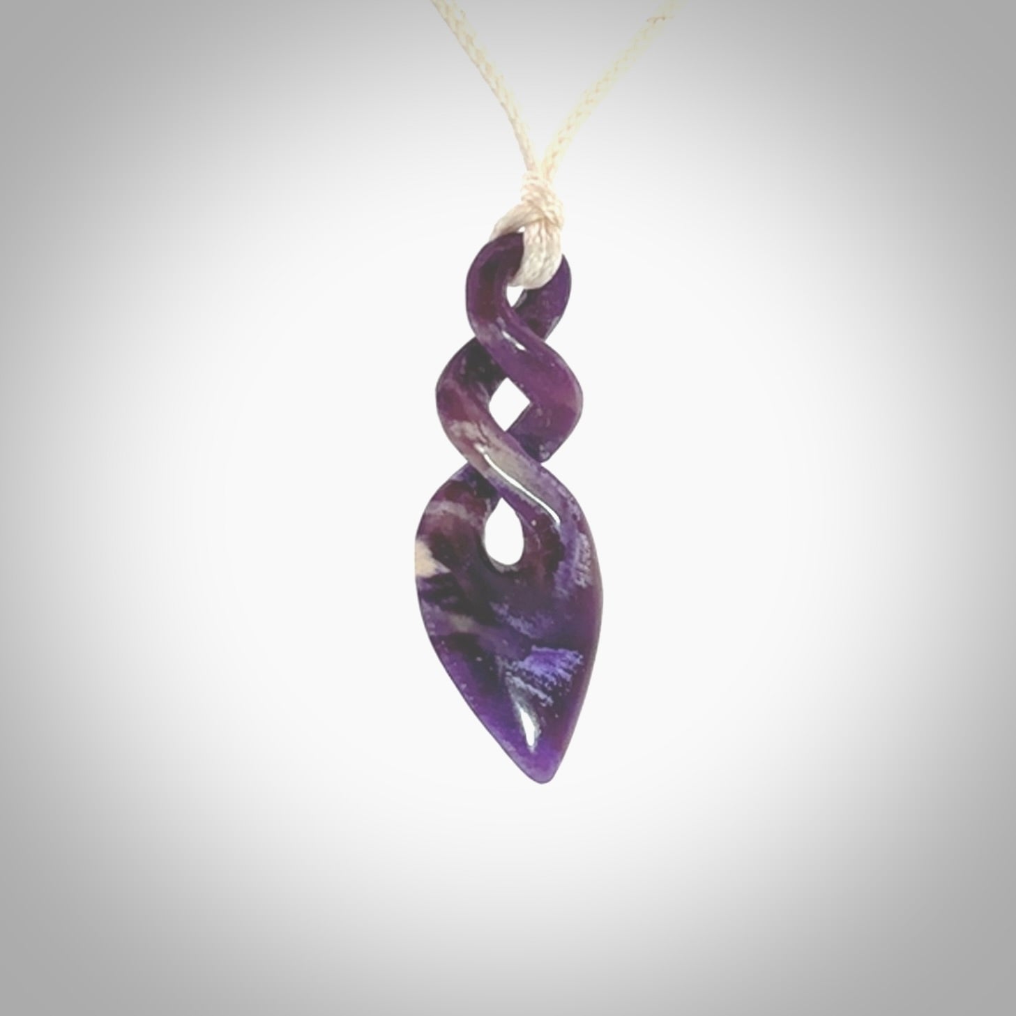 Hand carved woolly mammoth tusk double twist pendant. Made by NZ Pacific.