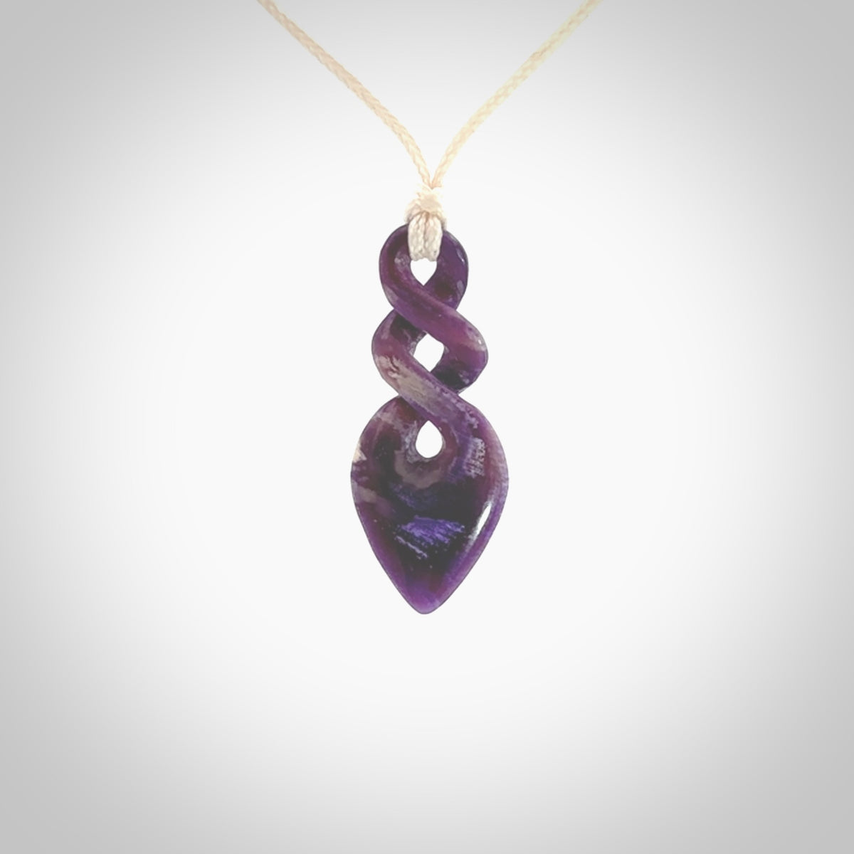 Hand carved woolly mammoth tusk double twist pendant. Made by NZ Pacific.