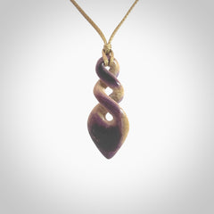 Hand carved woolly mammoth tusk double twist pendant. Made by NZ Pacific.