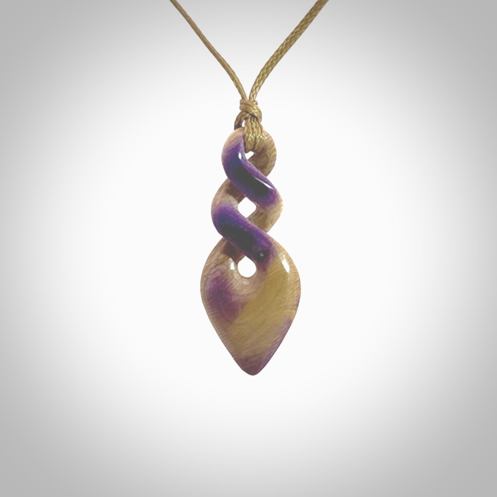 Hand carved woolly mammoth tusk double twist pendant. Made by NZ Pacific.