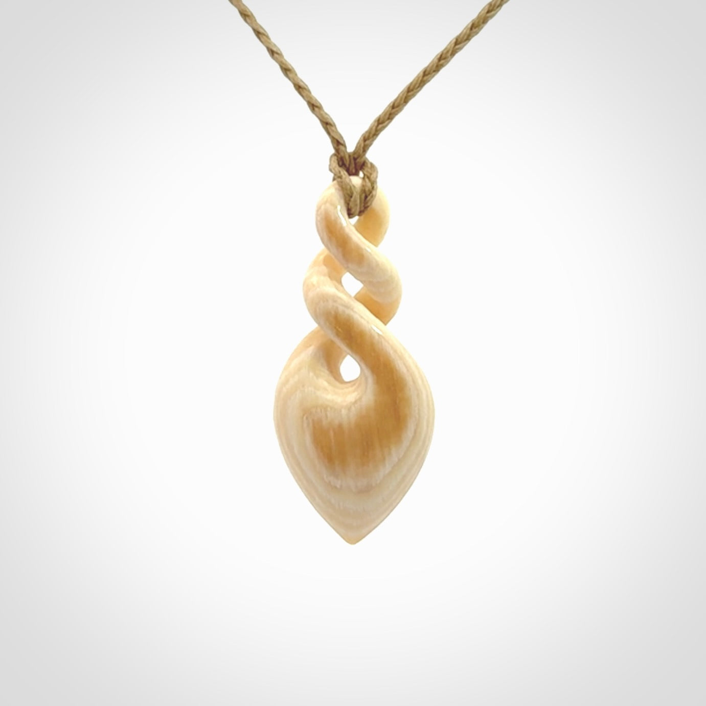 Elegant and striking twist pendants carved from mammoth tusk that's over 30,000 years old - a beautiful and ancient material.
