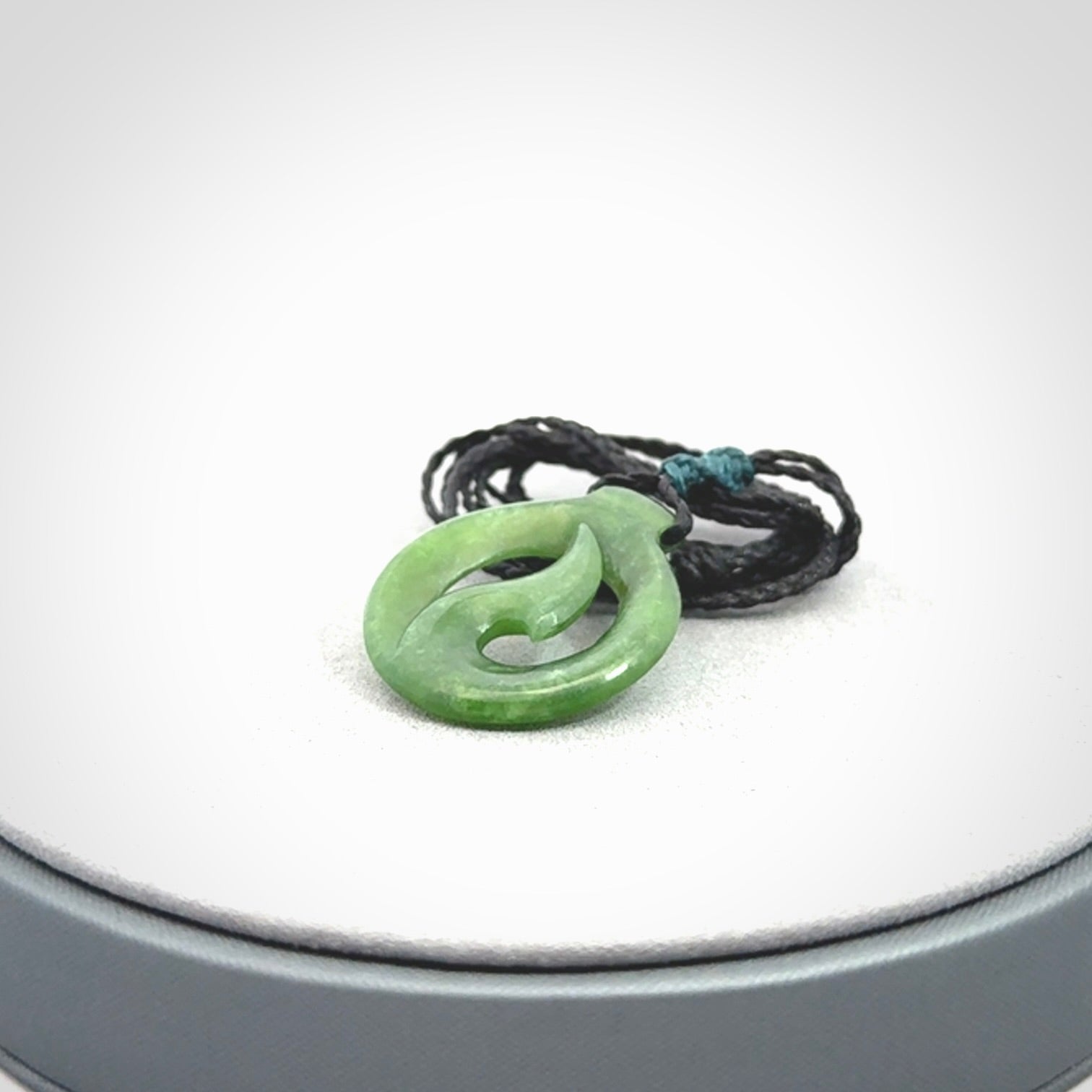 Jade matau or hook pendant. Carved from New Zealand pounamu in New Zealand. Hand carved jade jewellery for sale online.