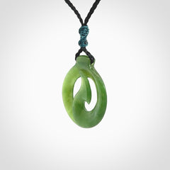 Jade matau or hook pendant. Carved from New Zealand pounamu in New Zealand. Hand carved jade jewellery for sale online.
