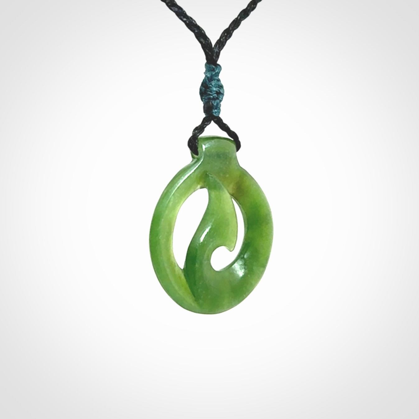 Jade matau or hook pendant. Carved from New Zealand pounamu in New Zealand. Hand carved jade jewellery for sale online.