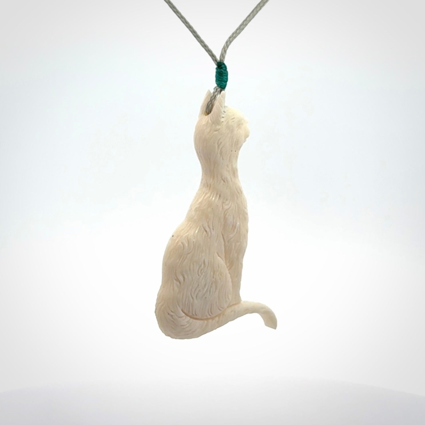 Hand carved bone cat pendant