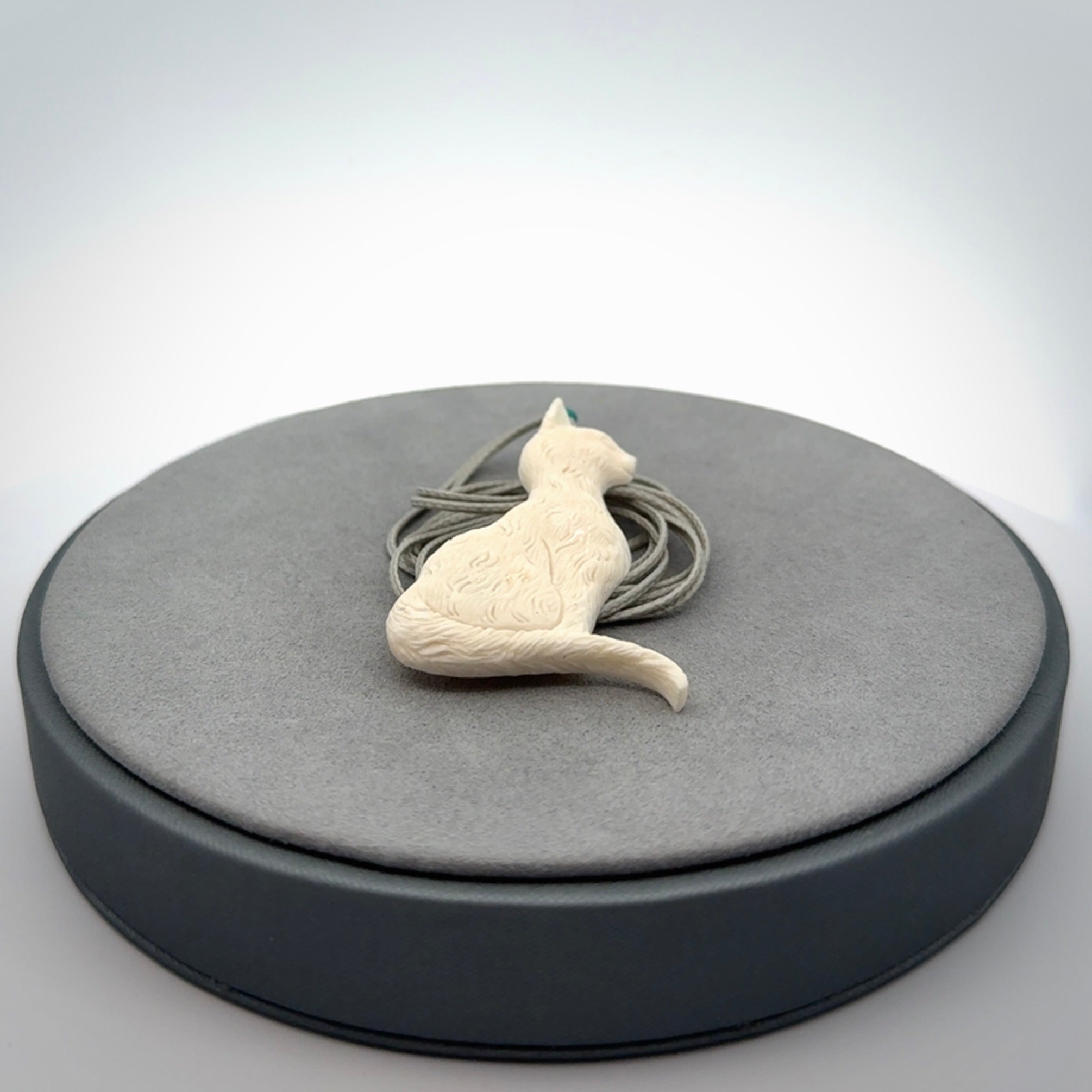 Hand carved bone cat pendant