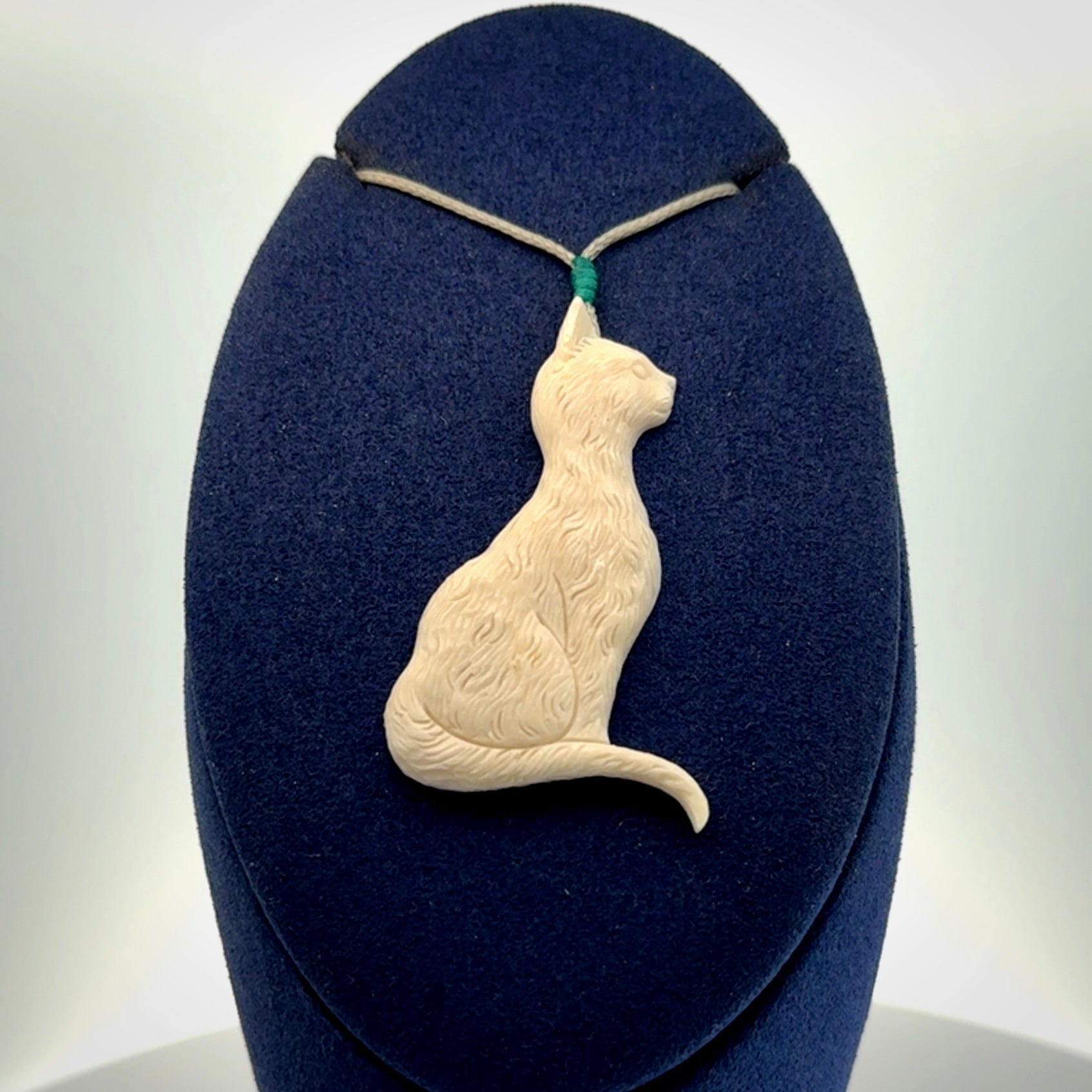 Hand carved bone cat pendant