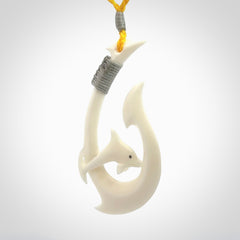 Hand carved bone hook with dolphin pendant. This is a marine-themed pendant which we have made for dolphin lovers and for those of us that love the sea. This piece is handcarved from natural bone and is shipped worldwide free.