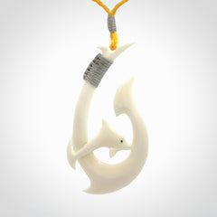 Hand carved bone hook with dolphin pendant. This is a marine-themed pendant which we have made for dolphin lovers and for those of us that love the sea. This piece is handcarved from natural bone and is shipped worldwide free.