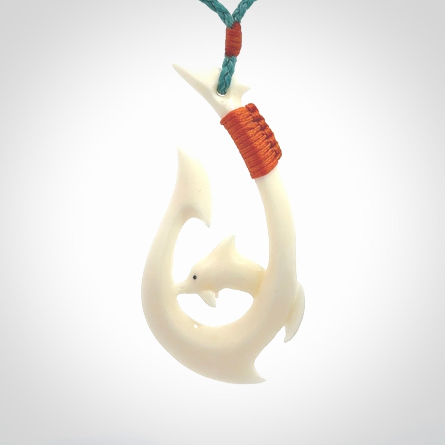 Hand carved bone hook with dolphin pendant. This is a marine-themed pendant which we have made for dolphin lovers and for those of us that love the sea. This piece is handcarved from natural bone and is shipped worldwide free.